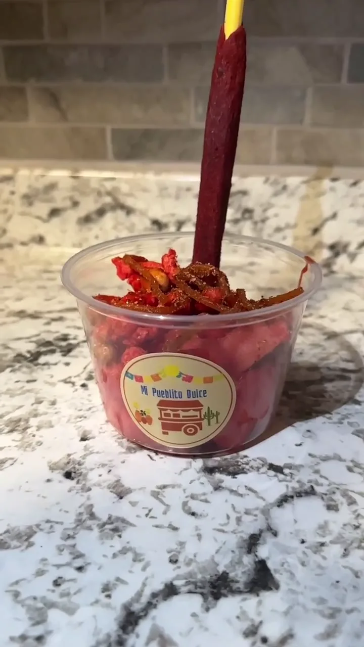 Branded fruit cup finished with chamoy, Tajín and a tamarind straw